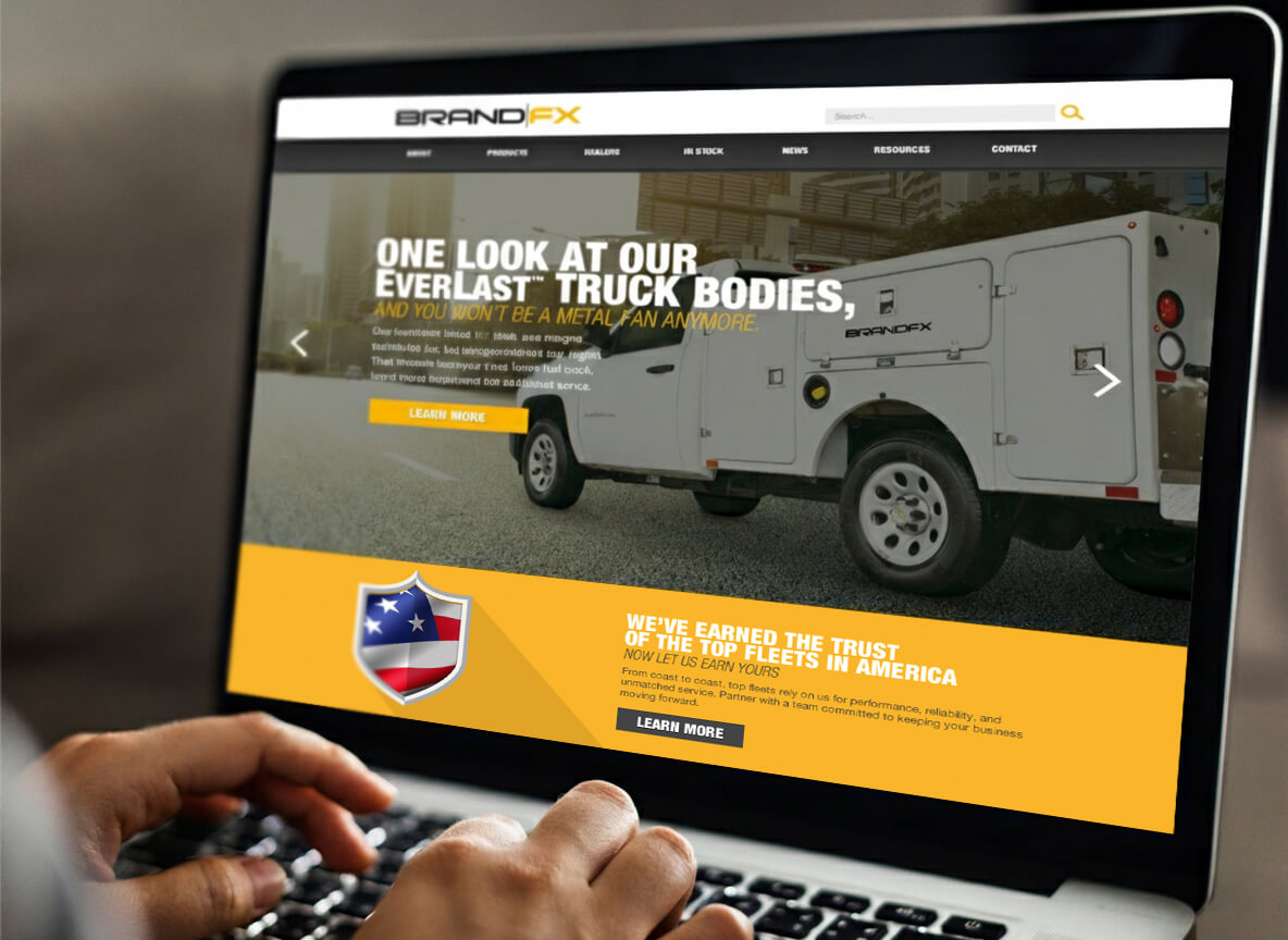 Laptop screen displaying the BrandFX website with a white service truck on the homepage.