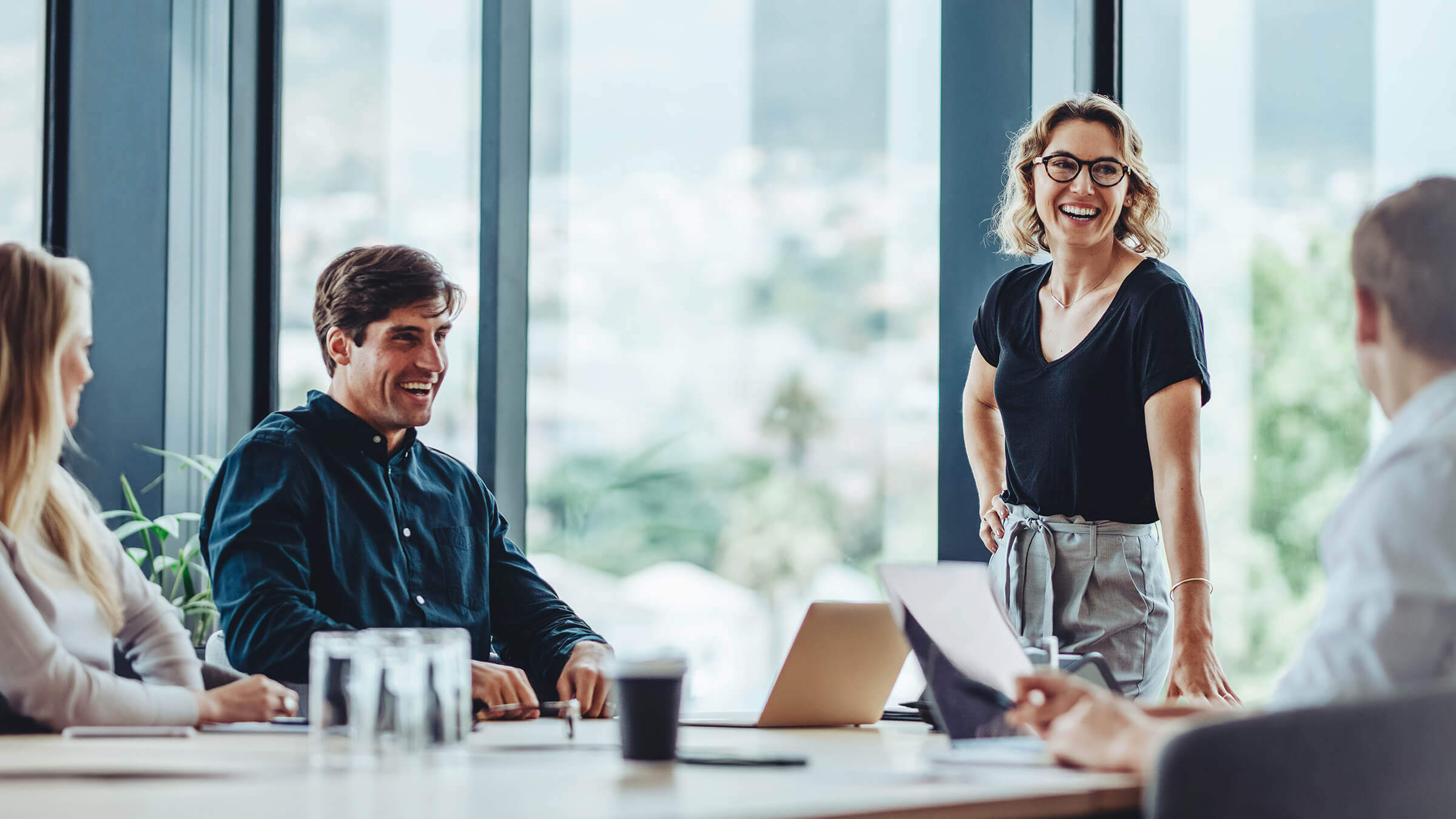 B2B marketing agency team collaborating with a client during a strategy discussion in a modern office setting.